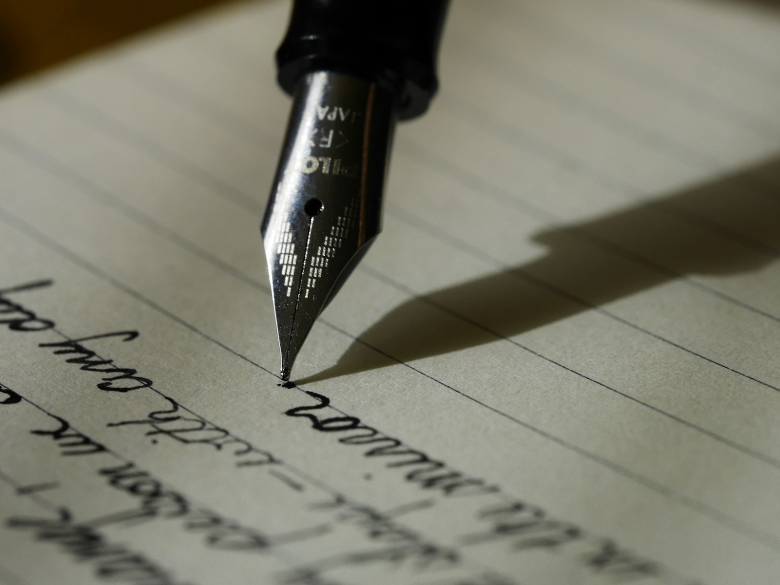 Writer taking notes beside a laptop for website content planning
